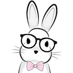 A headshot of a rabbit wearing glasses and a pink bowtie.
